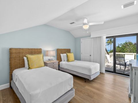 Bedroom with two twin beds and yellow pillows