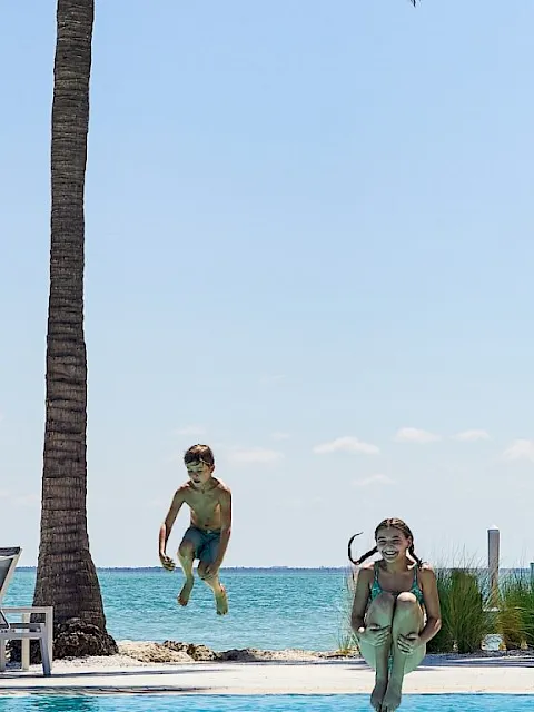 Children jumping into a pool at South Seas