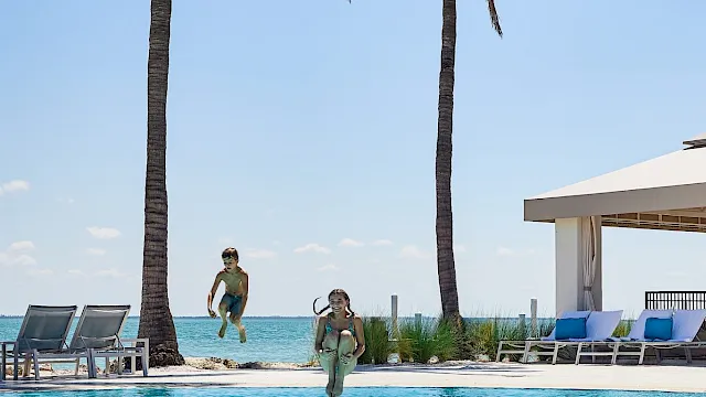 Children jumping into a pool at South Seas